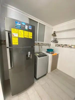 a small kitchen with a refrigerator and a sink at LIVING CARTAGENA Apto de lujo in Cartagena de Indias
