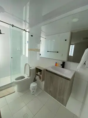a white bathroom with a toilet and a sink at LIVING CARTAGENA Apto de lujo in Cartagena de Indias
