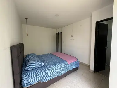 a small bedroom with a bed in the corner at Apartamento 2 habitaciones Paraiso, by Accommdo360 in Barranquilla