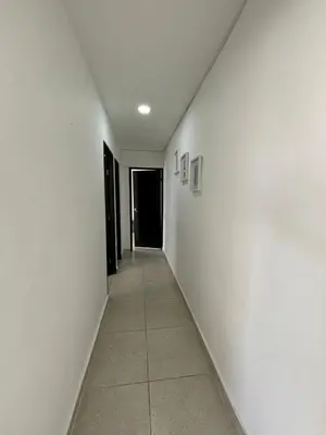 a hallway with white walls and a tile floor at Apartamento 2 habitaciones Paraiso, by Accommdo360 in Barranquilla