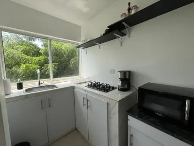 a small kitchen with a sink and a microwave at Apartamento 2 habitaciones Paraiso, by Accommdo360 in Barranquilla