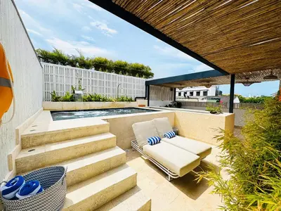 a patio with a chair and a swimming pool at Casa Bugó Arsenal Hotel Boutique en Getsemaní in Cartagena de Indias