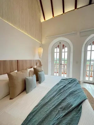 a large bedroom with a large bed with pillows at Casa Bugó Arsenal Hotel Boutique en Getsemaní in Cartagena de Indias