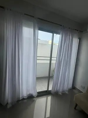 a room with a window with white curtains at Apartamentos Cartagena Acuarium in Cartagena de Indias