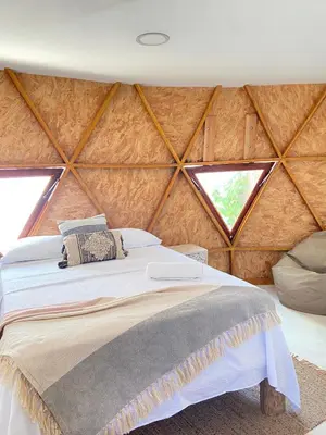 a bedroom with a bed in a wooden wall at Casa de playa Kommox Beach in Cartagena de Indias