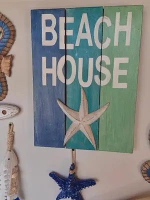 a sign on a wall with a beach houston sign at Casa de playa Kommox Beach in Cartagena de Indias