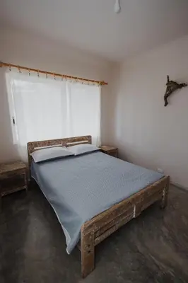 a bedroom with a wooden bed in a room at Apartamento Atlantic 111 in La Perdiz