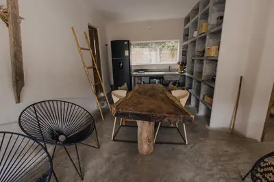 a room with a table and chairs and a refrigerator at Apartamento Atlantic 111 in La Perdiz