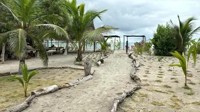 a playground on a beach with palm trees at Apartamento Atlantic 111 in La Perdiz