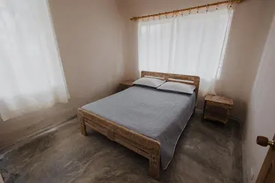 a small bedroom with a bed and a window at Apartamento Atlantic 111 in La Perdiz