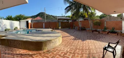 a patio with a pool and a table and a chair at Cabaña la casa de vero in Santa Veronica