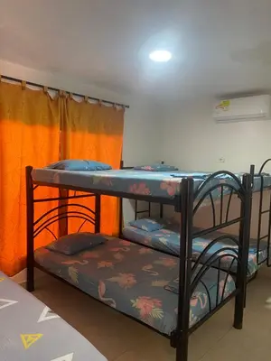 two bunk beds in a room with an orange curtain at Cabaña la casa de vero in Santa Veronica