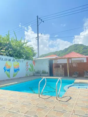 a swimming pool in front of a building at Cabaña la casa de vero in Santa Veronica