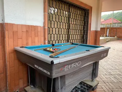 a pool table in front of a building at Cabaña la casa de vero in Santa Veronica
