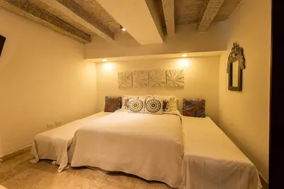 a bedroom with a large white bed in a room at Luxury Colonial Home at Virrey Eslava in Cartagena de Indias