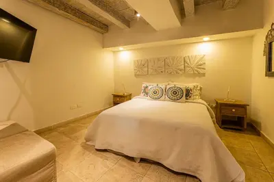 a bedroom with a large white bed with two night stands at Luxury Colonial Home at Virrey Eslava in Cartagena de Indias