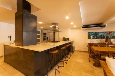 a large kitchen with a counter and a table at Luxury Colonial Home at Virrey Eslava in Cartagena de Indias