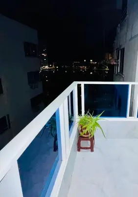 a potted plant sitting on a balcony at night at Apartamento remodelado cómodo y cerca al mar in Cartagena de Indias