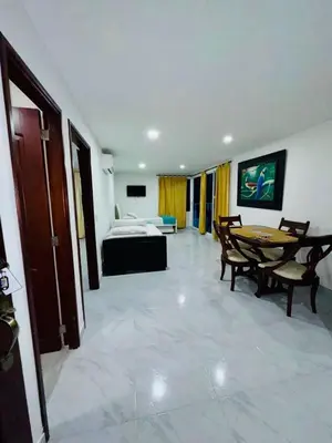 a large room with a bed and a table in it at Apartamento remodelado cómodo y cerca al mar in Cartagena de Indias