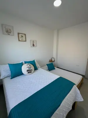 a bedroom with two beds with blue and white at 203 Apartamento Frente al Mar in San Bernardo del Viento