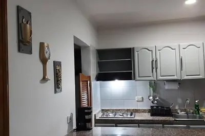 a kitchen with white cabinets and a counter top at Cómodo Ap Frente al mar, cerca a la murallas in Cartagena de Indias
