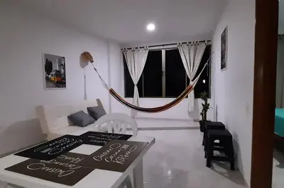 a living room with a couch and a hammock at Cómodo Ap Frente al mar, cerca a la murallas in Cartagena de Indias