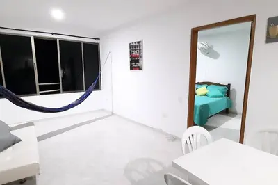 a room with a bedroom with a bed and a mirror at Cómodo Ap Frente al mar, cerca a la murallas in Cartagena de Indias