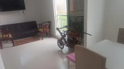 a living room with a black couch and a balcony at apartamento Amazilia en alameda del rio in Barranquilla