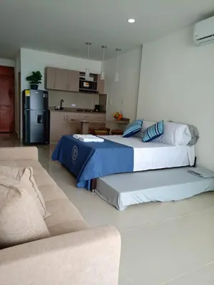 a living room with two beds and a couch at Cartagena Aparta Suite con Vista al Mar in Cartagena de Indias