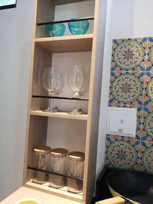 a wooden shelf with wine glasses on it at Azul in Santa Marta