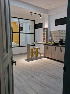 a large kitchen with a table and a counter at Azul in Santa Marta