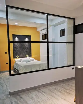a bedroom with a bed in a large glass window at Azul in Santa Marta