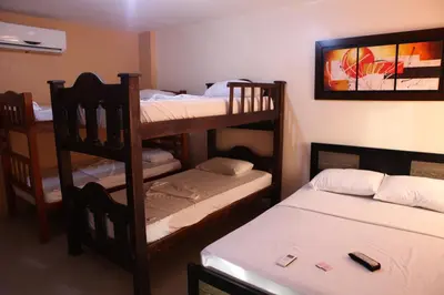 a room with three bunk beds and two beds at Hotel Boquilla Suites By GEH Suites in Cartagena de Indias