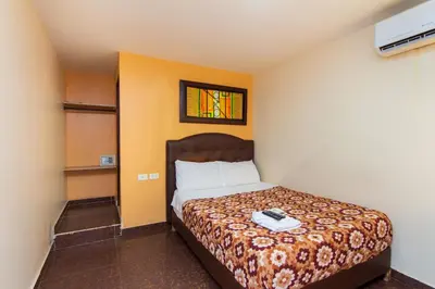 a bedroom with a bed in a room at Hotel Boquilla Suites By GEH Suites in Cartagena de Indias