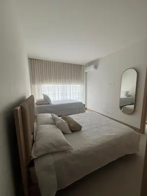a bedroom with two beds and a mirror at Apartamento en Cartagena in Cartagena de Indias