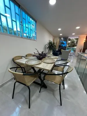 a dining room with a table and chairs at Cabaña salgar - la casa de la playa in Puerto Salgar