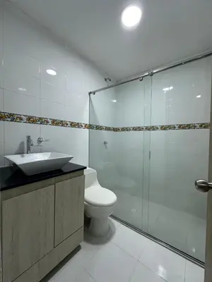 a bathroom with a toilet and a glass shower at Cabaña salgar - la casa de la playa in Puerto Salgar