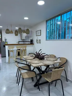 a dining room with a table and chairs at Cabaña salgar - la casa de la playa in Puerto Salgar