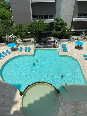 an overhead view of a large swimming pool with people in it at Bello Horizonte Suite in Santa Marta