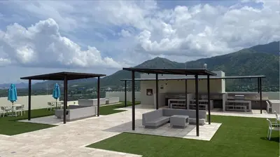 a patio with chairs and umbrellas on top of a building at Bello Horizonte Suite in Santa Marta