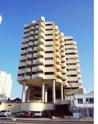 a large apartment building with cars parked in front of it at apto con vista al mar piso 11- in Cartagena de Indias