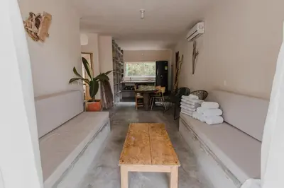 a living room with a table and a bench at Apartamento Atlantic 112 in La Perdiz