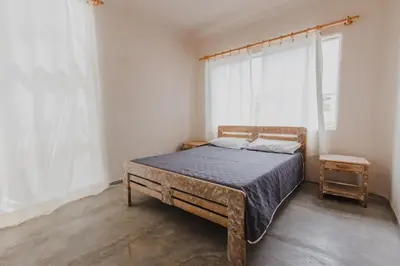 a bedroom with a large bed with a blue blanket at Apartamento Atlantic 211 in La Perdiz