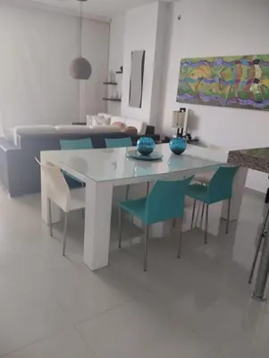 a white table and chairs in a living room at Apartamentos Mi Reserva OK - Bahía Marina in Coveñas