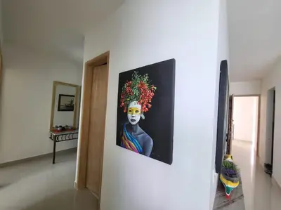 a painting of a woman with areath on her head on a wall at Apartamentos Mi Reserva OK - Bahía Marina in Coveñas