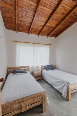 two beds in a room with wooden ceilings at Apartamento Atlantic 311 in La Perdiz