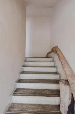 a staircase in a building with a stone railing at Apartamento Atlantic 311 in La Perdiz