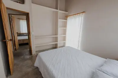 a bedroom with a bed and a window and a door at Apartamento Atlantic 311 in La Perdiz