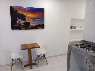 a kitchen with a table and chairs and a painting on the wall at Casa Marbella in Cartagena de Indias