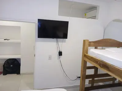 a room with a flat screen tv on the wall at Casa Marbella in Cartagena de Indias